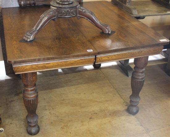 Late Victorian oak extending dining table and two leaves